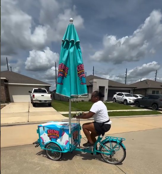 The Kreme Cruiser cart being pedaled down a residential street
