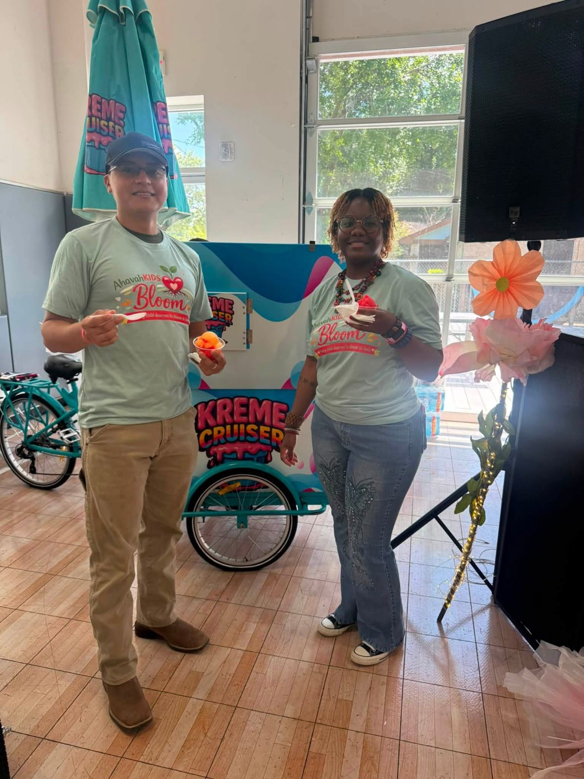 Kreme Cruiser servers in branded shirts serving water ice at an indoor event
